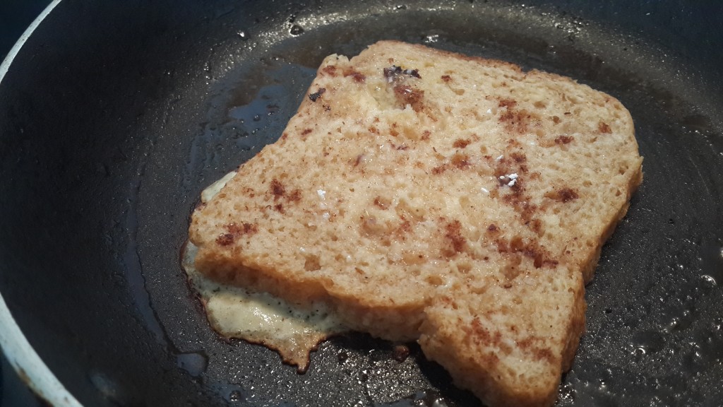 French toast sprinkled with cinnamon powder and caster sugar, in progress