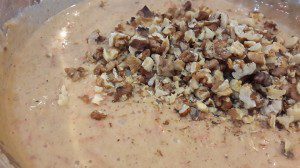 Adding walnuts to the carrot cake batter