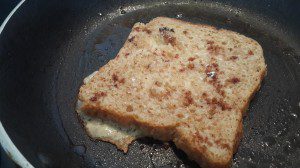 French toast sprinkled with cinnamon powder and caster sugar, in progress