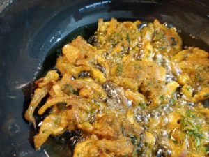 Frying onion pakodas or bhajjis